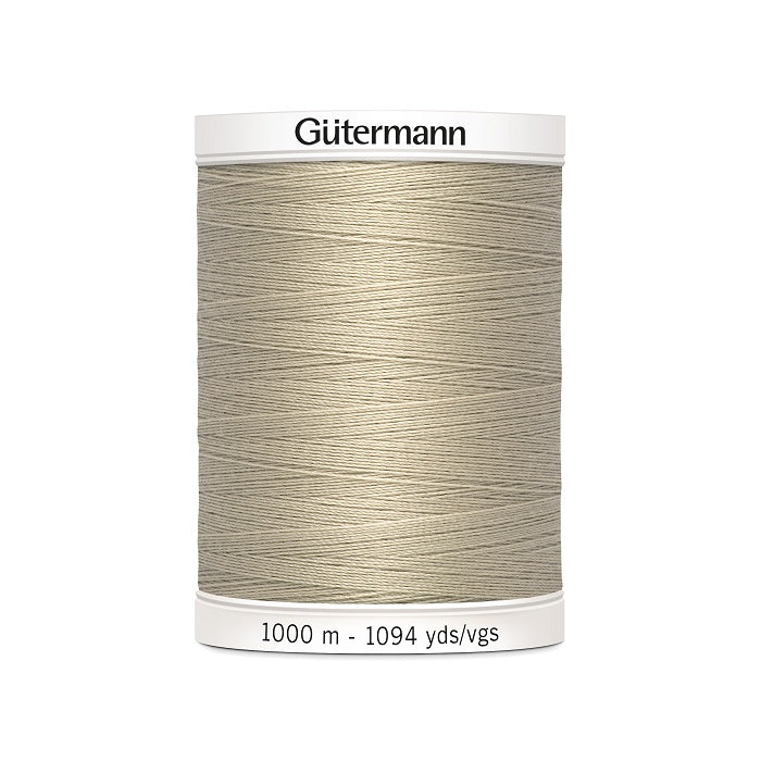 Beige sewing thread spool with Gutermann branding.