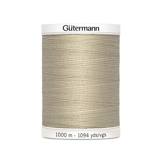 Beige sewing thread spool with Gutermann branding.