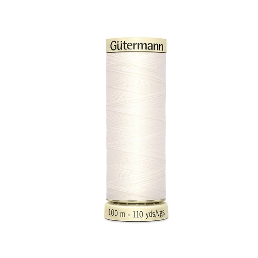 Spool of off white thread with Gutermann branding.