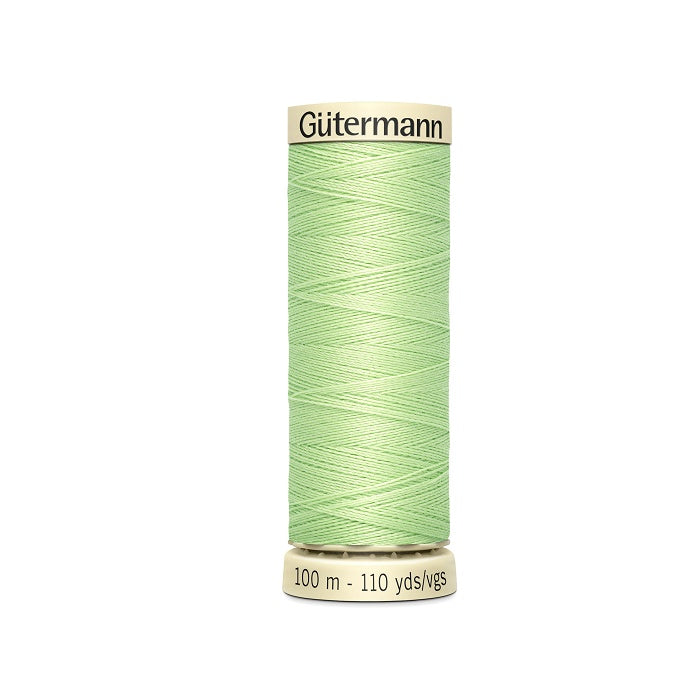 Spool of light green thread with Gutermann branding.