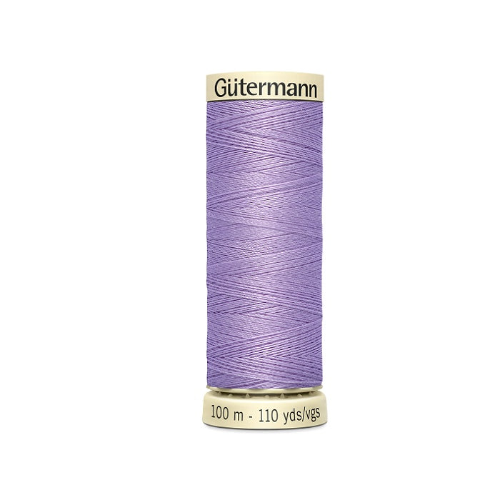 Spool of mauve purple thread with Gutermann branding.