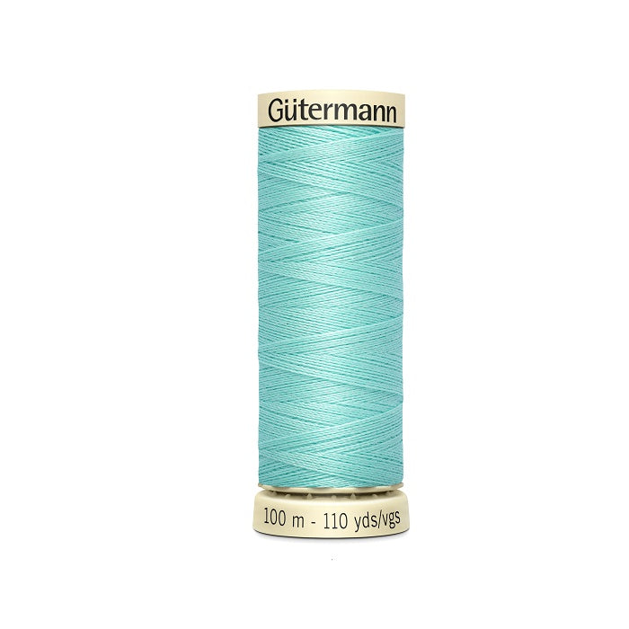 Spool of light blue thread with Gutermann branding.