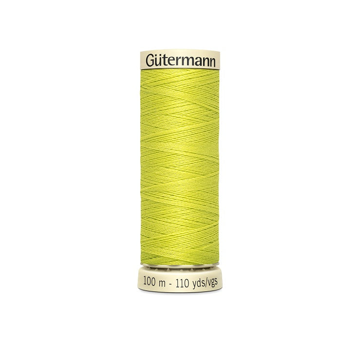 Spool of yellow thread with Gutermann branding.