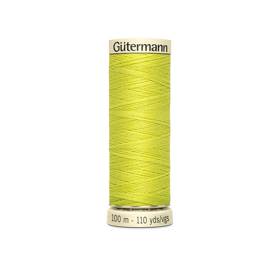 Spool of yellow thread with Gutermann branding.