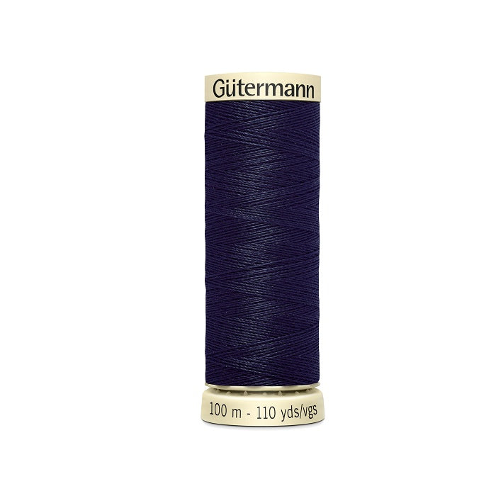 Spool of navy blue thread with Gutermann branding.