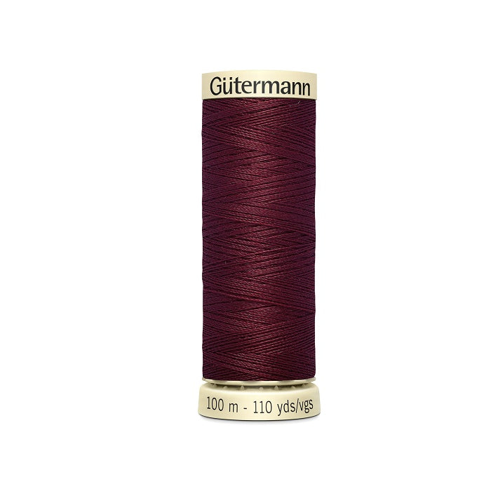 Spool of burgundy red thread with Gutermann branding.