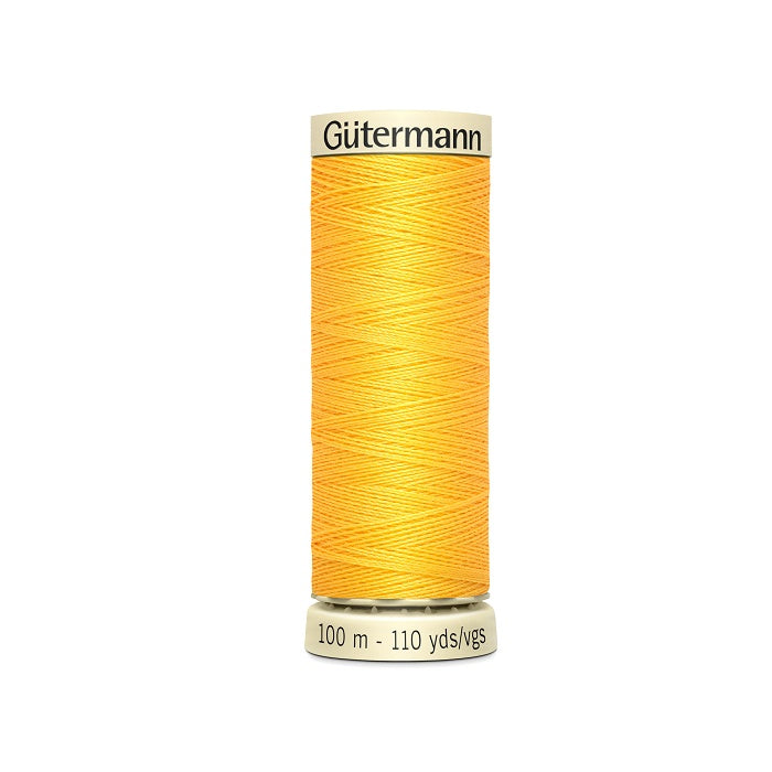 Spool of yellow thread with Gutermann branding.