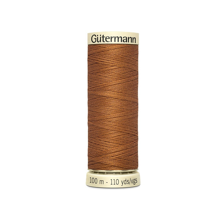 Spool of brown thread with Gutermann branding.