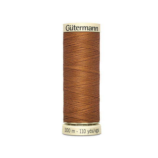 Spool of brown thread with Gutermann branding.