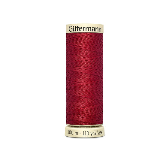 Spool of red thread with Gutermann branding.