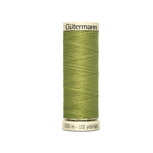 Spool of green thread with Gutermann branding.
