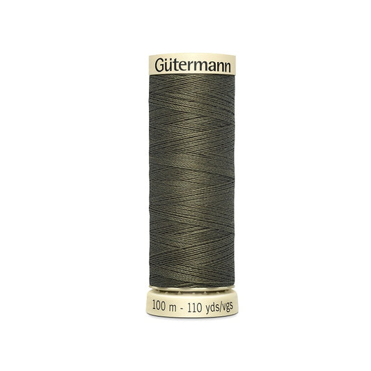Spool of dark olive green thread with Gutermann branding.