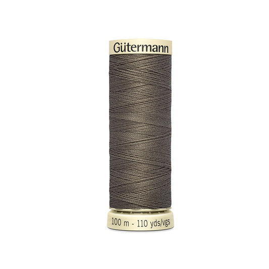 Spool of brown thread with Gutermann branding.