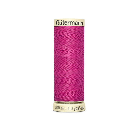 Spool of dusty rose pink thread with Gutermann branding.