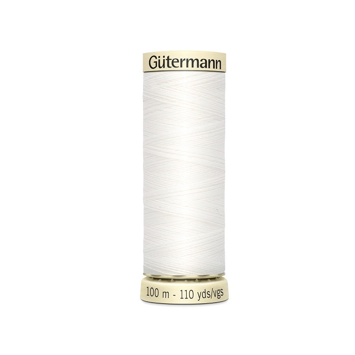 Spool of white thread with Gutermann branding.