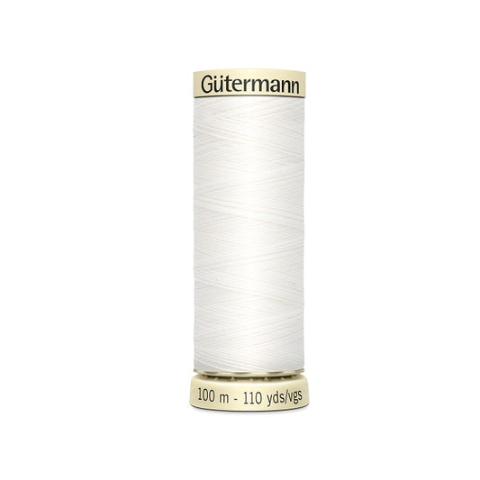 Spool of white thread with Gutermann branding.