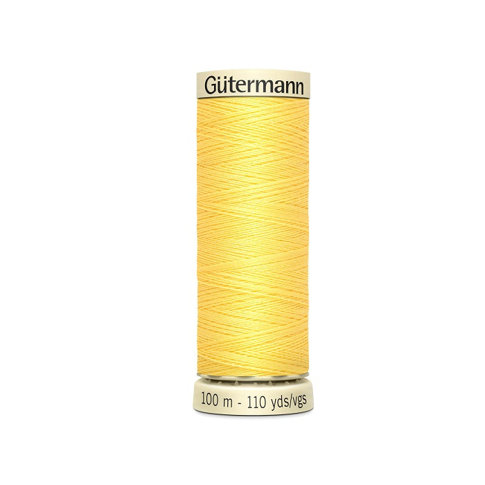 Spool of yellow thread with Gutermann branding.