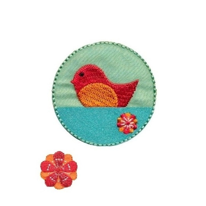 Round patch with red and orange bird on water.