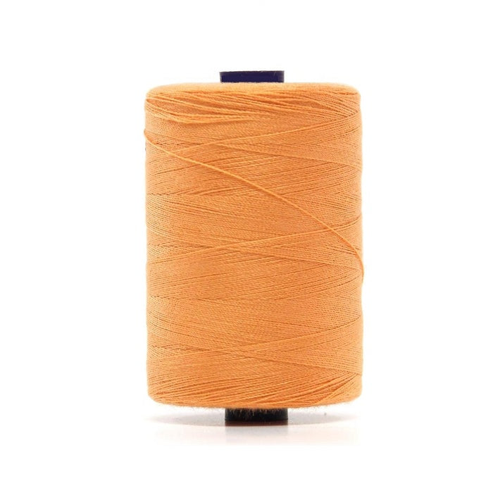 Spool of apricot polyester sewing thread.