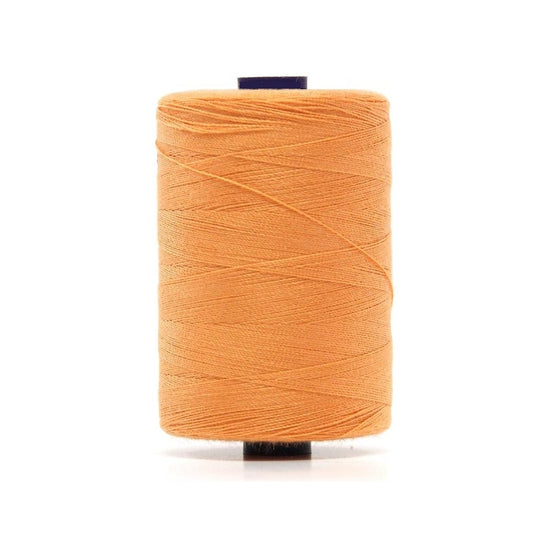 Spool of apricot polyester sewing thread.