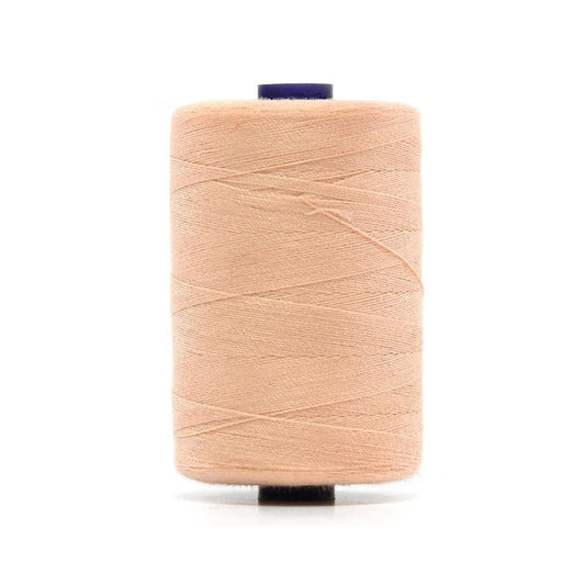 Spool of peach polyester sewing thread.