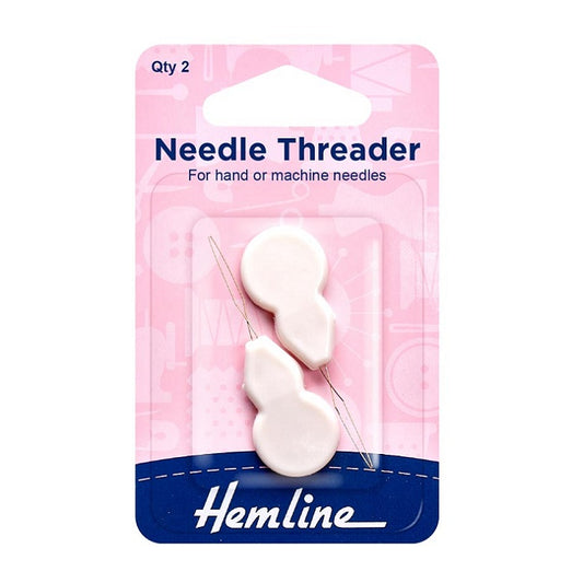 Two small white plastic needle threaders in Hemline packaging.