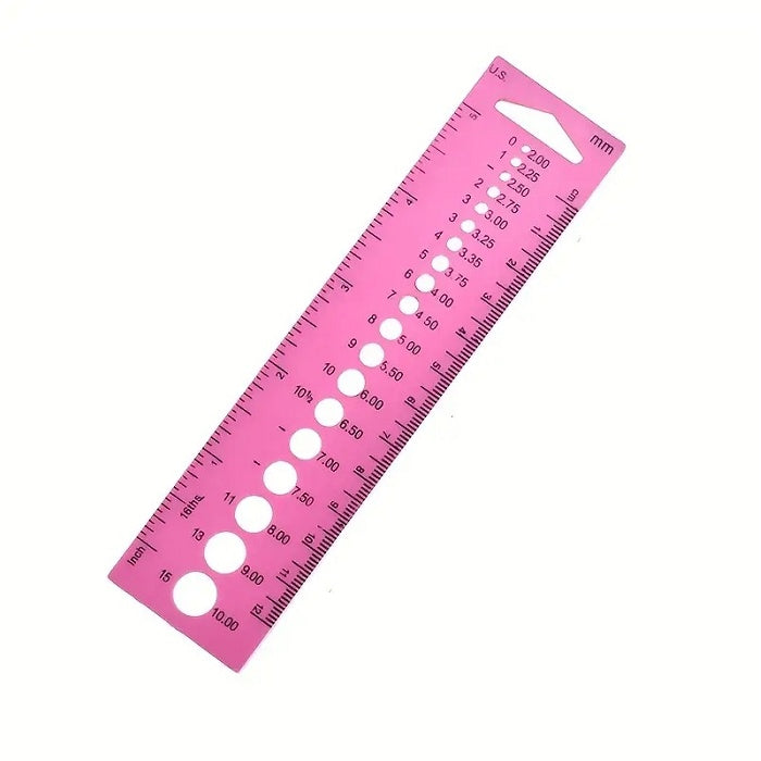 Pink plastic knitting needle gauge.