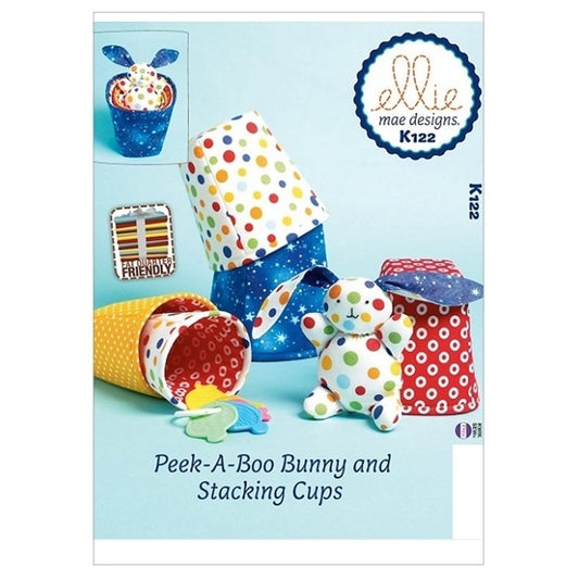 Sewing pattern cover with toy bunny and fabric stacking cups.