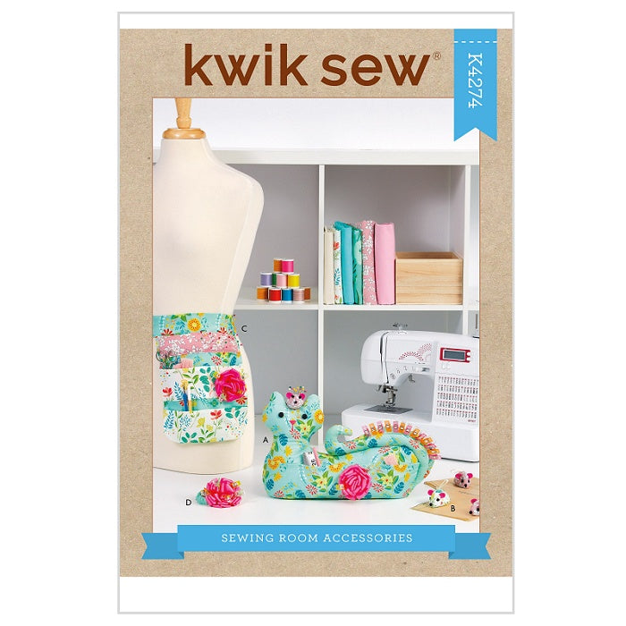 Sewing pattern cover with cat themed sewing room accessories.