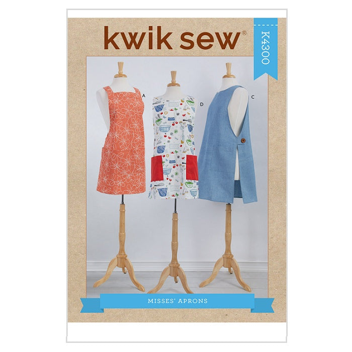 Sewing pattern cover with three aprons on tailors mannequins.