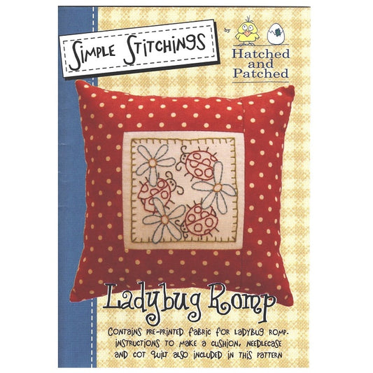 Pattern cover of red spotty cushion with embroidered ladybugs.