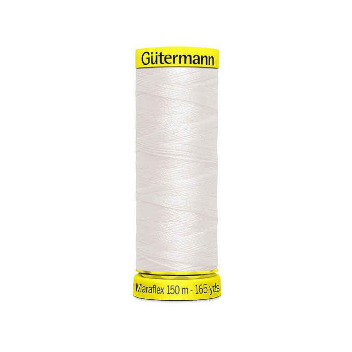 Spool of off white elastic thread with gutermann branding.