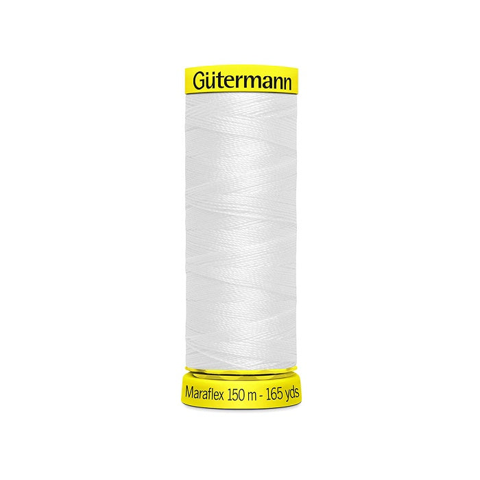 Spool of white elastic thread with gutermann branding.