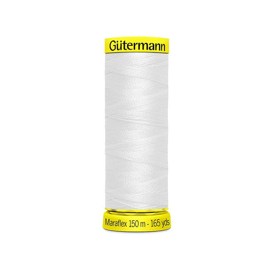 Spool of white elastic thread with gutermann branding.