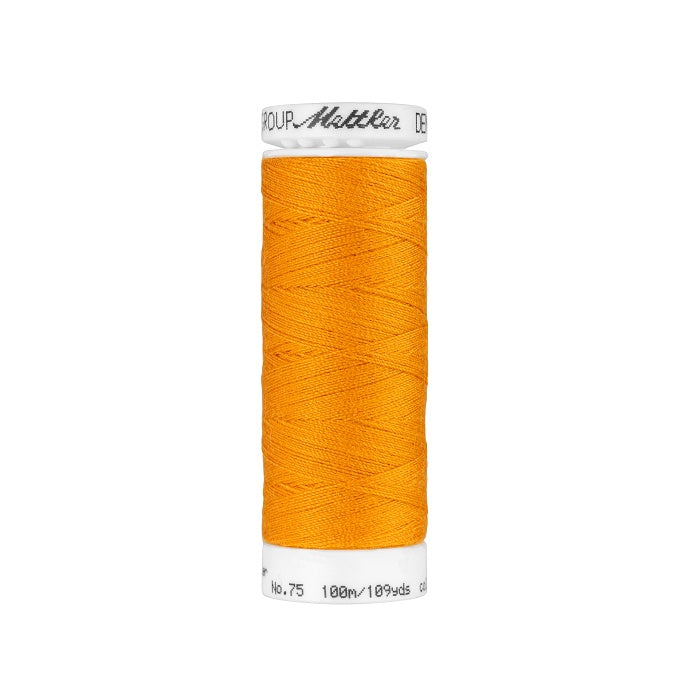 Spool of orange thread with Mettler branding.