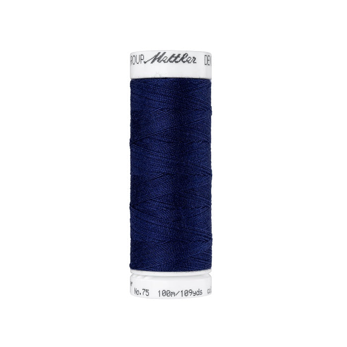 Spool of dark blue thread with Mettler branding.