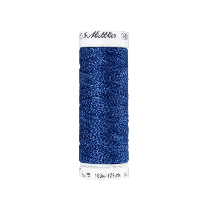 Spool of navy blue thread with Mettler branding.