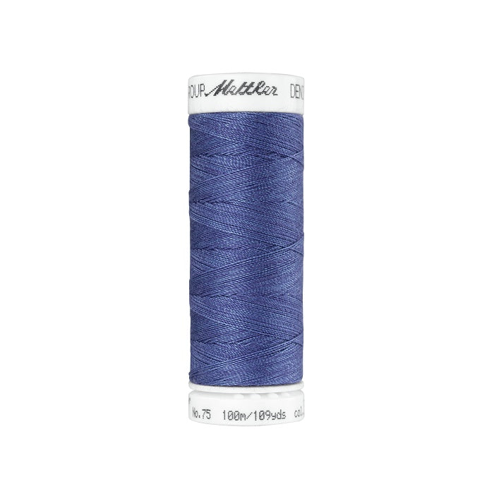 Spool of indigo blue thread with Mettler branding.