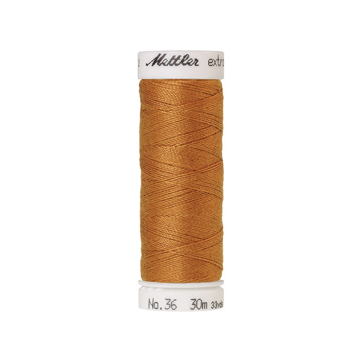 Spool of gold extra strong thread with Mettler branding.