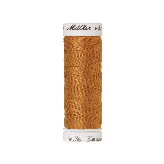 Spool of gold extra strong thread with Mettler branding.