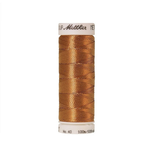 Spool of copper metallic thread with Mettler branding.