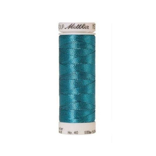 Spool of turquoise metallic thread with Mettler branding.