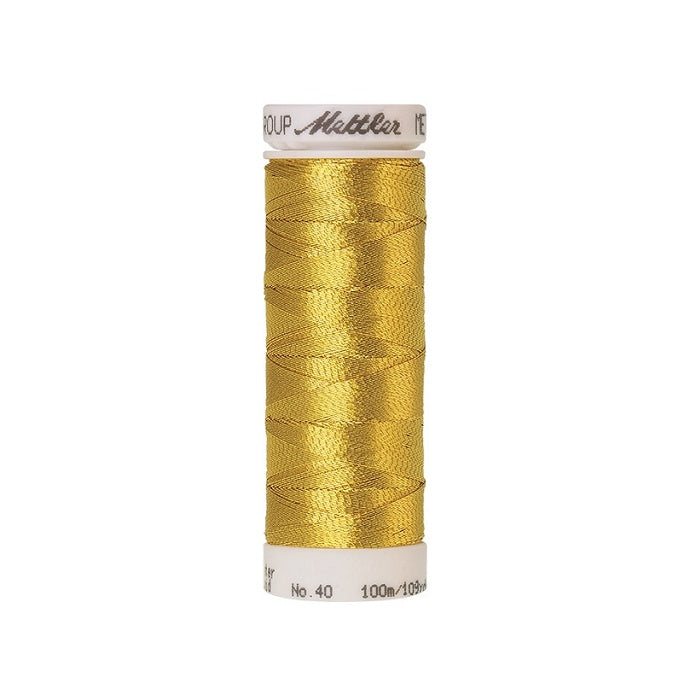 Spool of gold metallic thread with Mettler branding.