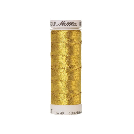 Spool of gold metallic thread with Mettler branding.