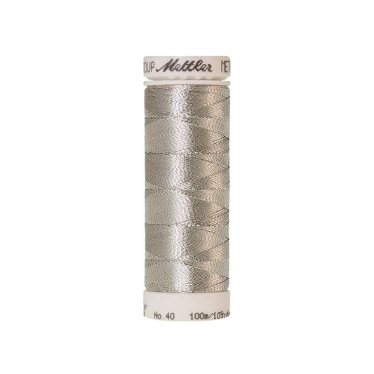 Spool of silver metallic thread with Mettler branding.