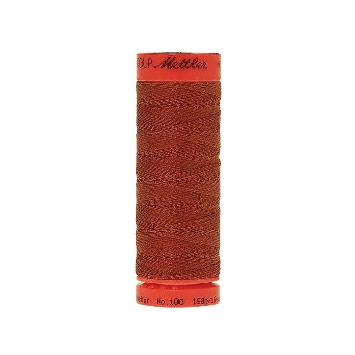 Spool of Mettler 150m brick red thread.