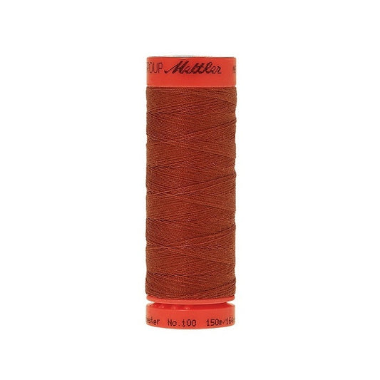 Spool of Mettler 150m brick red thread.