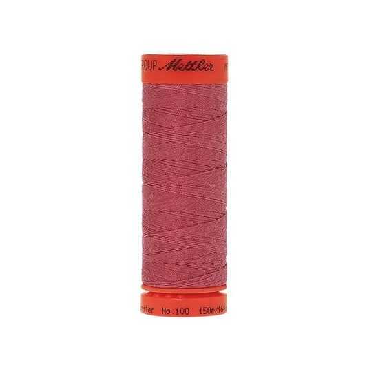 Spool of Mettler 150m dusky pink thread.