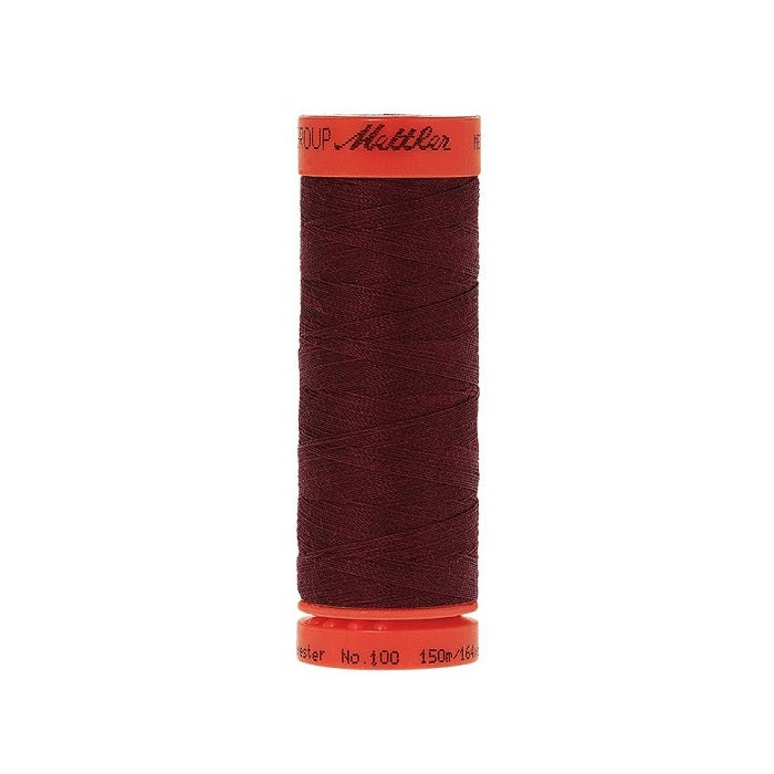 Spool of Mettler 150m burgundy thread.