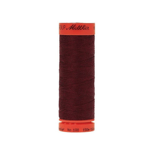 Spool of Mettler 150m burgundy thread.
